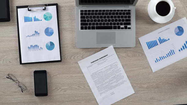 Purchase agreement lying on desk in boss office, business papers, top view