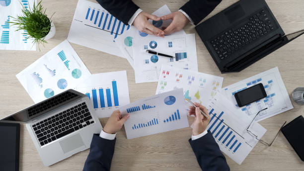 istock Two men checking business diagrams, discussing financial report, brainstorming 951483618