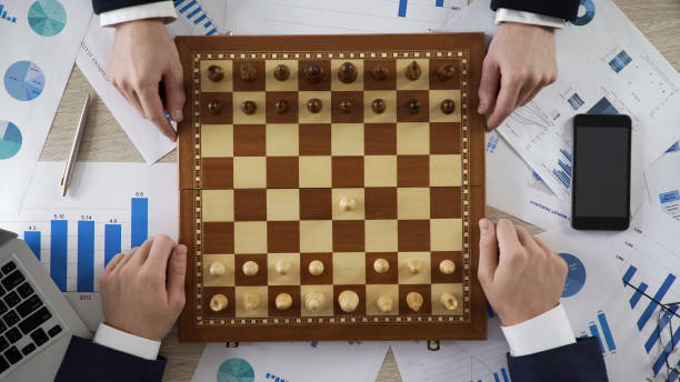 istock Company leaders playing chess, using business strategy to win market, top view 951484034