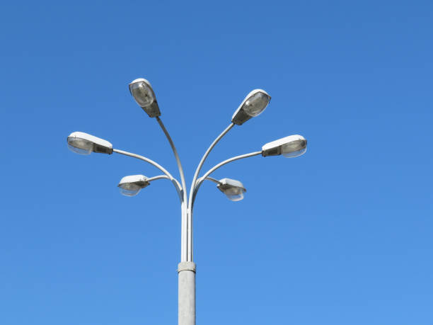 istock Street lamp with multiple lights isolated on clear blue sky background 951485168