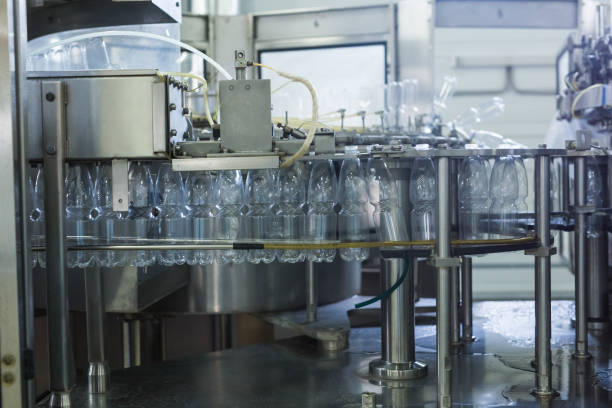 istock Water factory - Water bottling line for processing and bottling pure spring water into small bottles 951485586