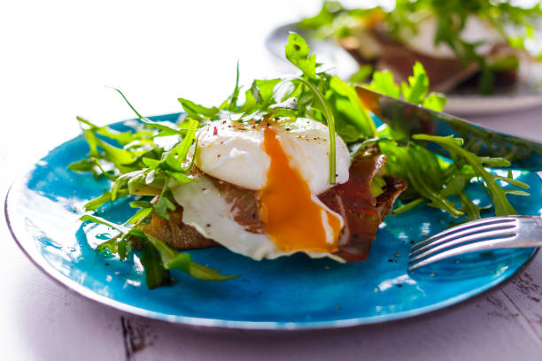 istock Toast with egg poached and rucola salad on a blue plate 951486014