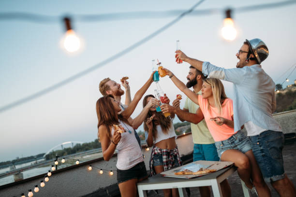 istock Friends having fun and drinking outdoor on a rooftop get together 951490064