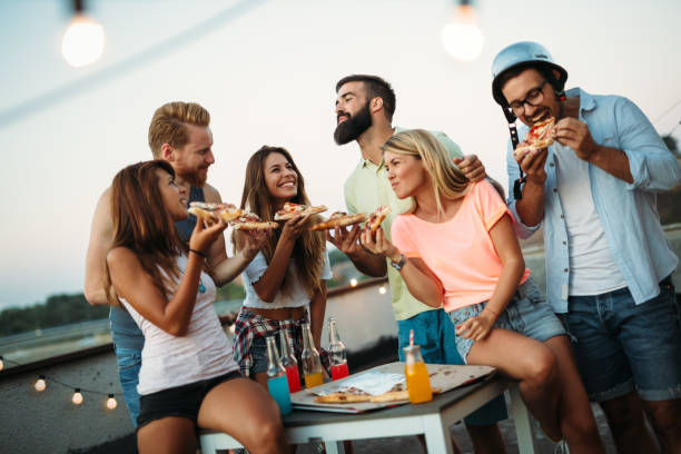 istock Group of happy friends having party on rooftop 951490702