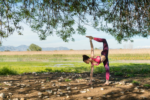 Woman practicing yoga, Anyalya, Turkey