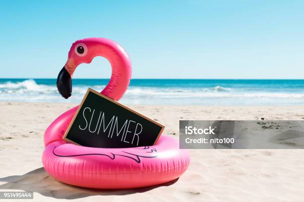 Flamingo Swim Ring On The Beach And Text Summer Stock Photo - Download Image Now - Summer, Beach, Taking A Break