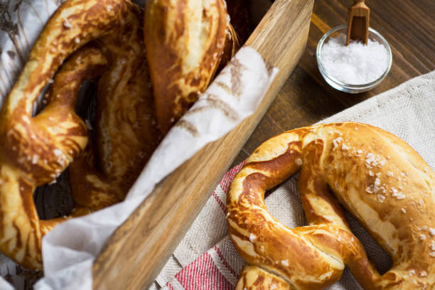 istock Pretzel with Sea Salt on Rustic Wooden Background 951495506
