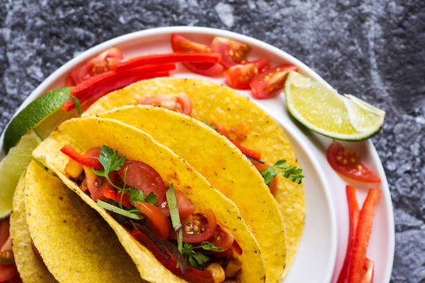 istock Tacos in Shells with Vegetables on Stone Background 951496244