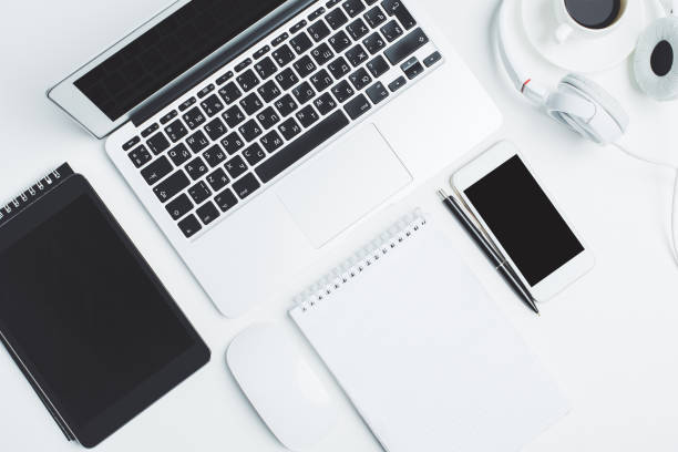 istock White desktop with devices and supplies 951496262