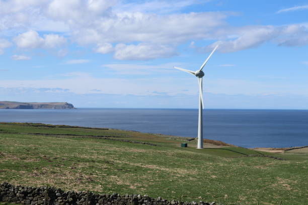 istock Wind turbine in field on cliff above North Sea 951499052