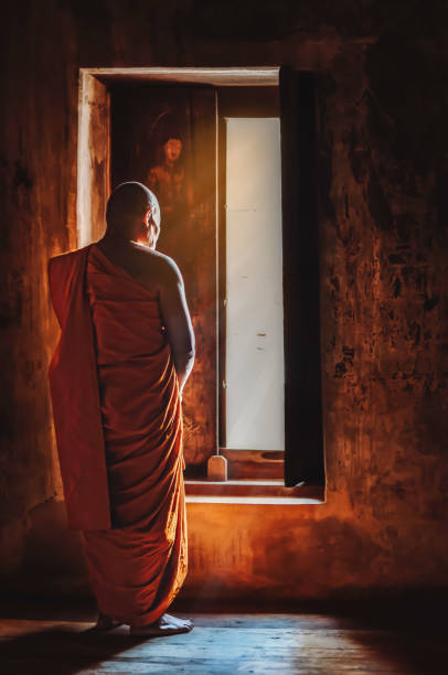 istock Buddhist monks are standing in front of windows in the morning light. 951499652