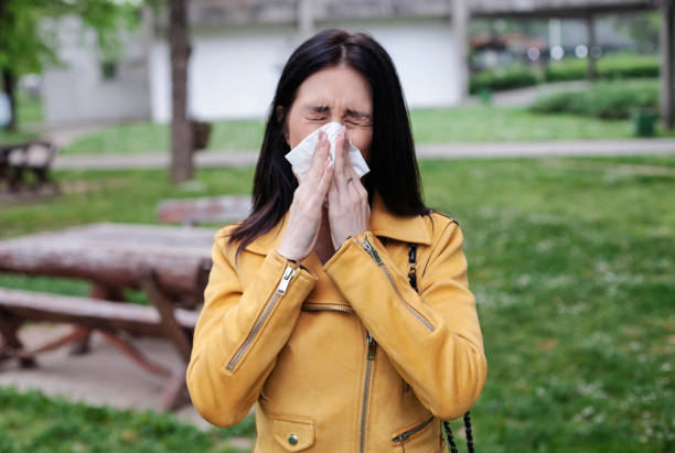 istock Young woman blowing her nose 951500584