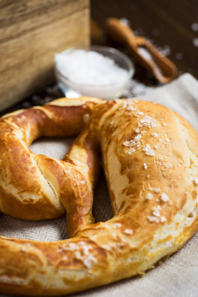istock Pretzel with Sea Salt on Rustic Wooden Background 951507200