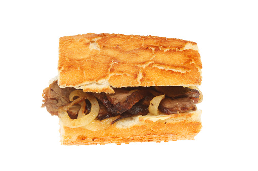 Steak and onion roll isolated against white