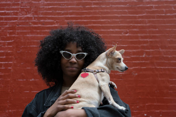Sisters with their dog on the street in Soho, Manhattan, NY