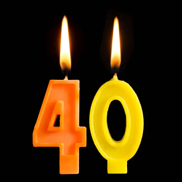 Burning birthday candles in the form of 40 forty figures for cake isolated on black background. The concept of celebrating a birthday, anniversary, important date, holiday