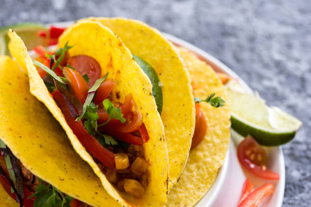 istock Tacos in Shells with Vegetables on Stone Background 951509916