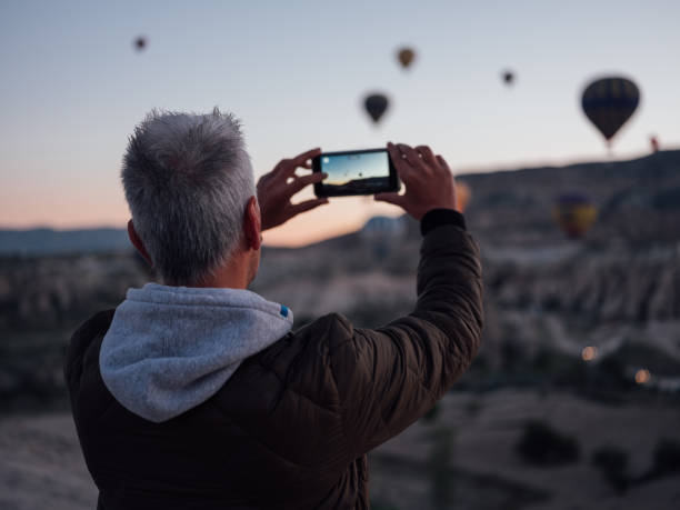 Taking a vertical picture at sunset Taking a vertical picture at sunset hot air balloon photos stock pictures, royalty-free photos & images