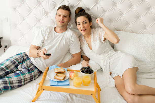 istock Young happy couple having breakfast in luxury room 951525032