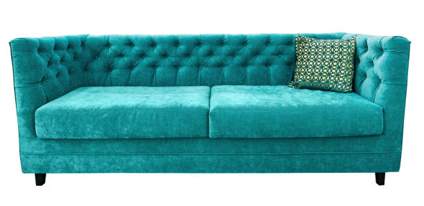 istock Turquoise velor sofa with pillow. Soft emerald couch. Isolated background 951539122