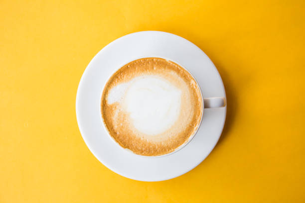 istock cup of coffee on yellow background 951542224