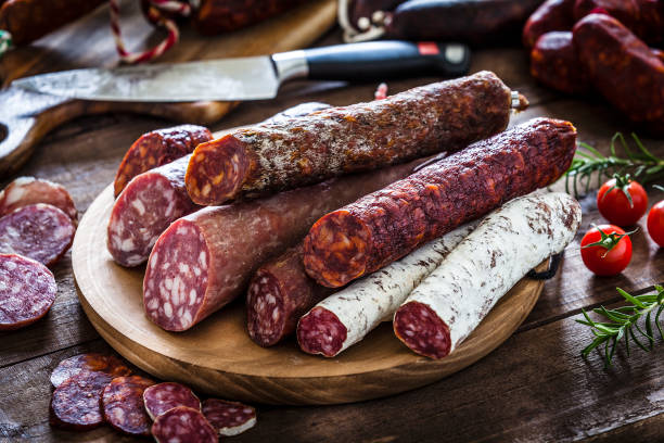 istock Mixed spanish chorizo pieces on rustic wooden table 951549098