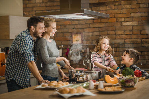 istock Happy family communicating while making lunch in the kitchen. 951550402