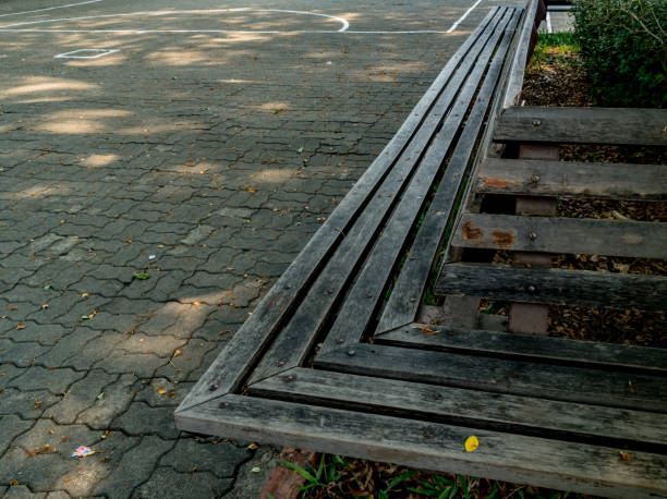 istock Wood bench on concrete floor 951554114