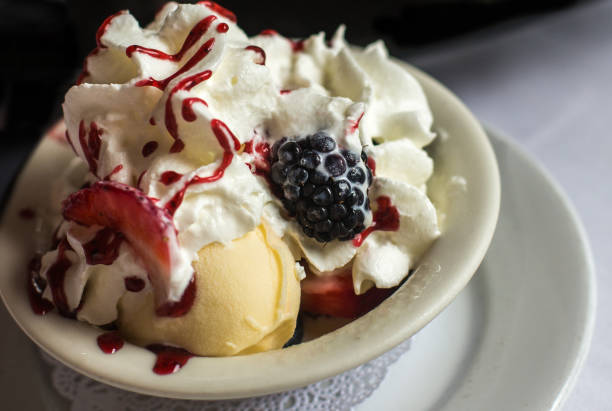istock ice cream with whipped cream and berries 951554174