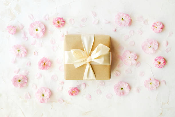istock Pink tulips and gift box on a white background. With easy removable sample text. 951572892