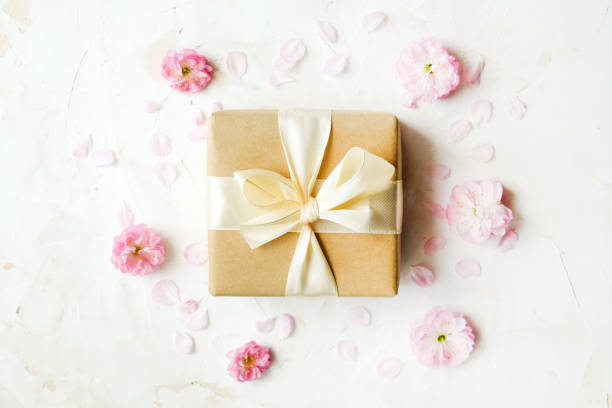 istock Pink tulips and gift box on a white background. With easy removable sample text. 951572898