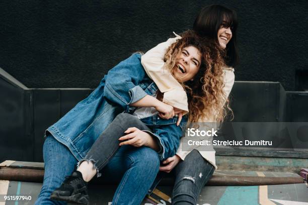 Two Beautiful Caucasian Girls Having Fun Laughing Embracing Stock Photo - Download Image Now