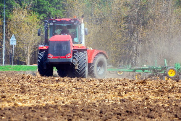 istock Farmer in tractor preparing land with seedbed cultivator 951614600