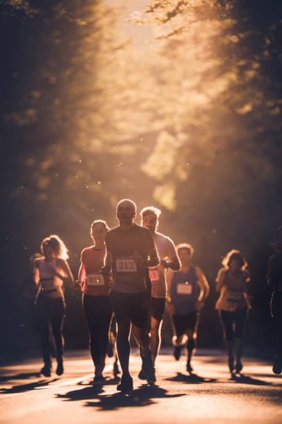 Two female runners jogging with dramatic cloudscape and city skyline in background