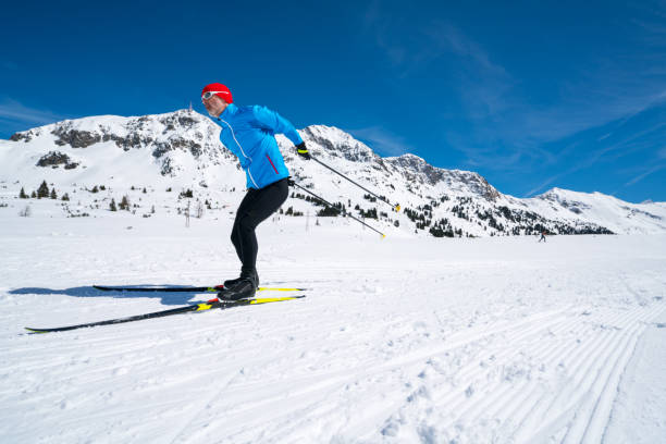 istock one man scross country skiing with blue sky 951632876