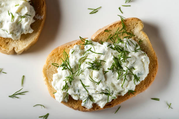 Appetizer with toast and homande cheese cream with fresh dill on plate stock photo