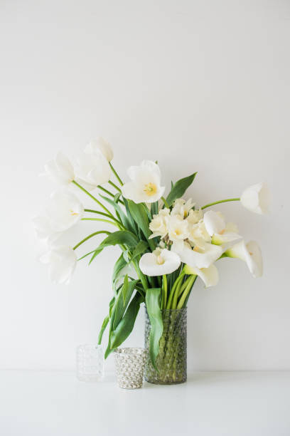 istock Large bouquet of white spring flowers in a vase, daffodils, tuli 951641784