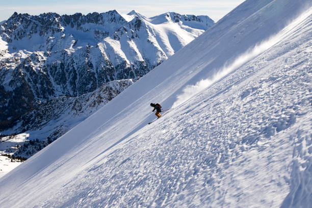 istock Young free skier riding down a steep off-piste terrain 951643738