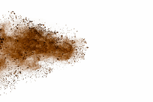 Explosion of brown dust on white background. Dry soil explosion on white background.