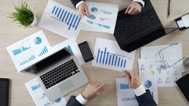 istock Auditors checking business documents of company, working on laptops, top view 951646026