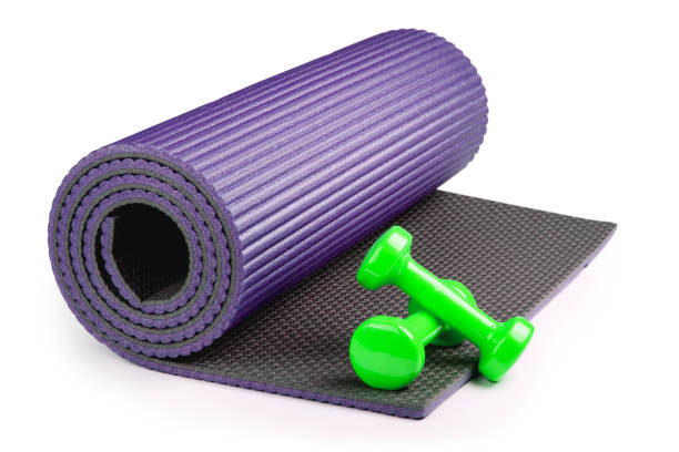 istock Yoga mat with dumbbells isolated on white background 951646488
