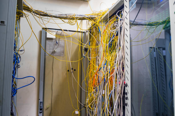 istock Messy yellow optic cables are randomly entangled with each other server in the data center room 951648380