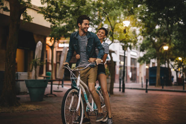 istock Loving couple riding bicycle on city road 951652170