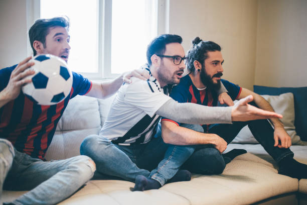 istock Anxious soccer fans watching game from home 951652450