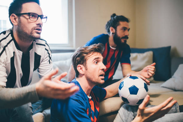 istock Male football supporters watching a game anxiously 951652478