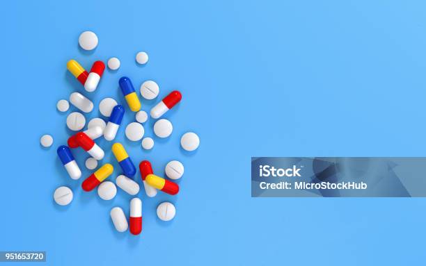 Pills On Blue Background Stock Photo - Download Image Now - Pill, Medicine, Capsule - Medicine