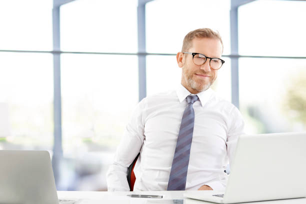 istock Middle aged businessman with laptop 951653808