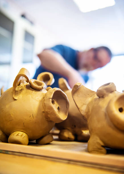 istock Mature artist moulding raw clay in art studio 951653992