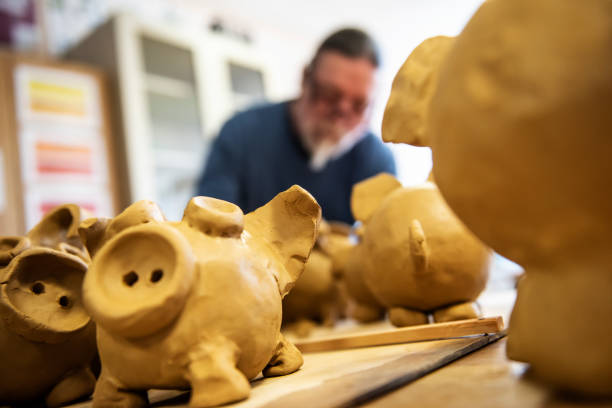 istock Mature artist moulding raw clay in art studio 951653996