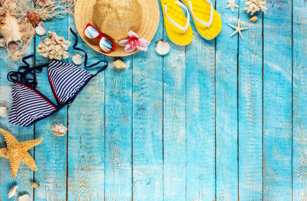 istock Beach accessories placed on blue wooden planks, top view. 951655264